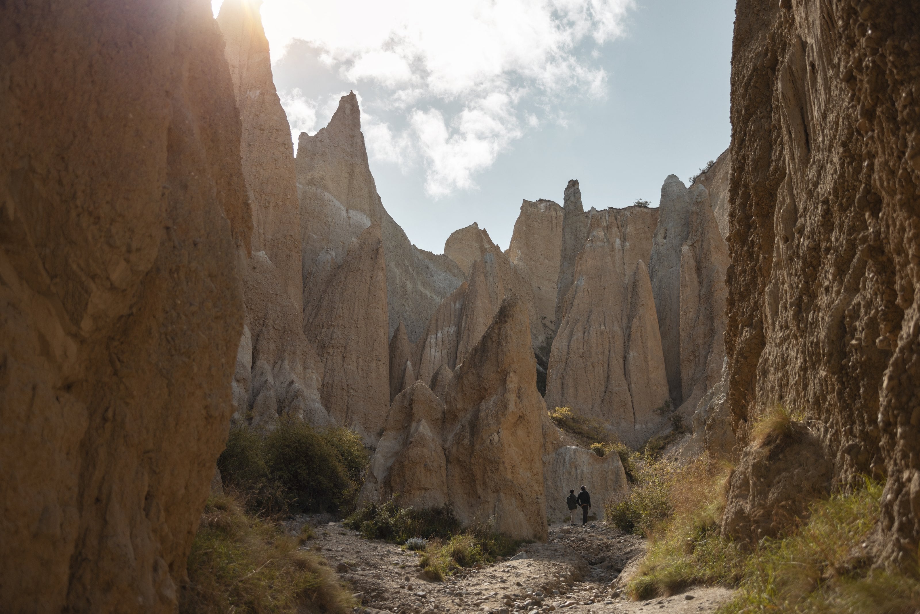 Two walkers among the pinnacles of the Clay Cliffs, Ōmārama