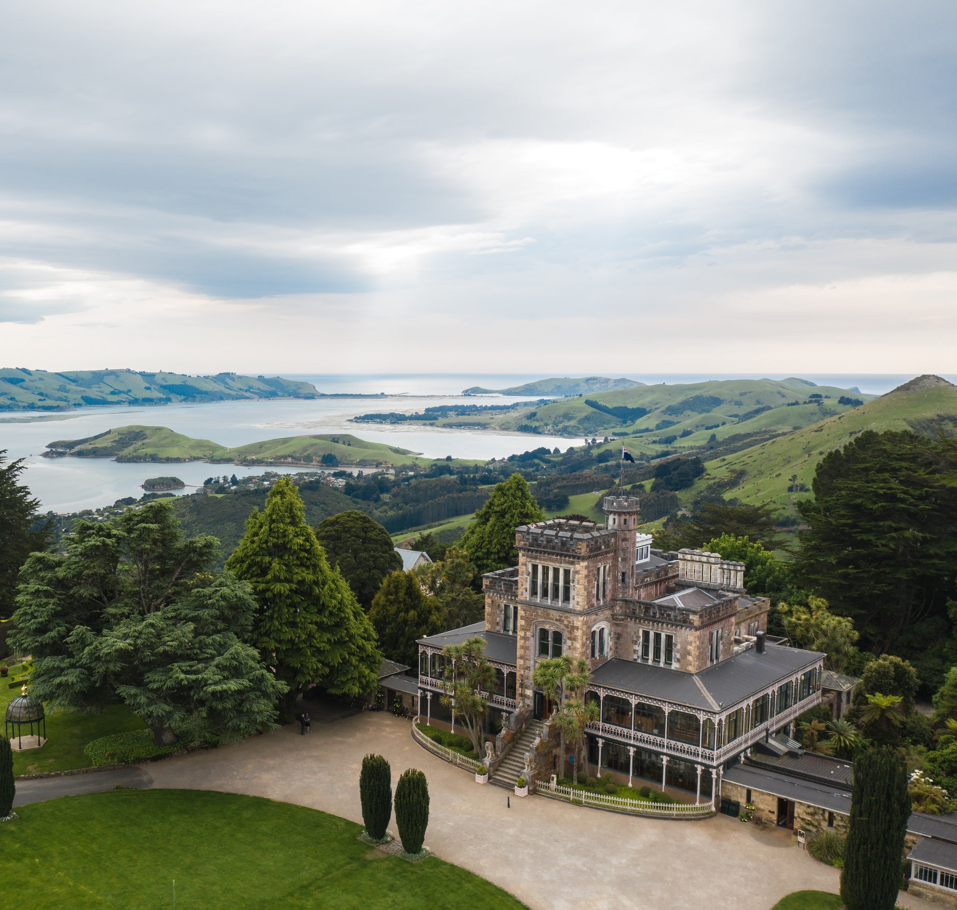 Larnach Castle from the air, Otago Harbour and the peninsula beyond