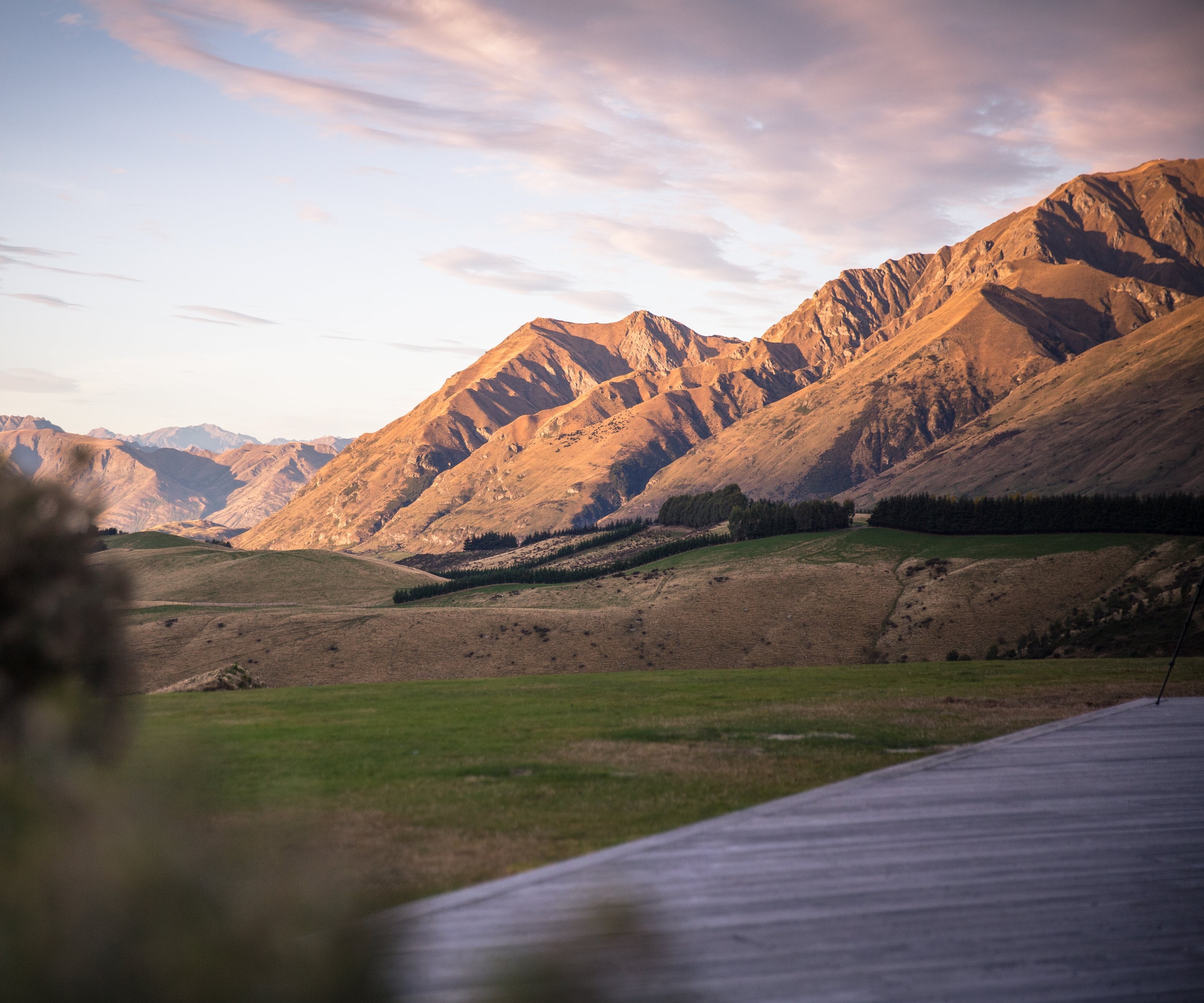 Evening light on the mountains above Wānaka, seen from the deck at Mahu Whenua