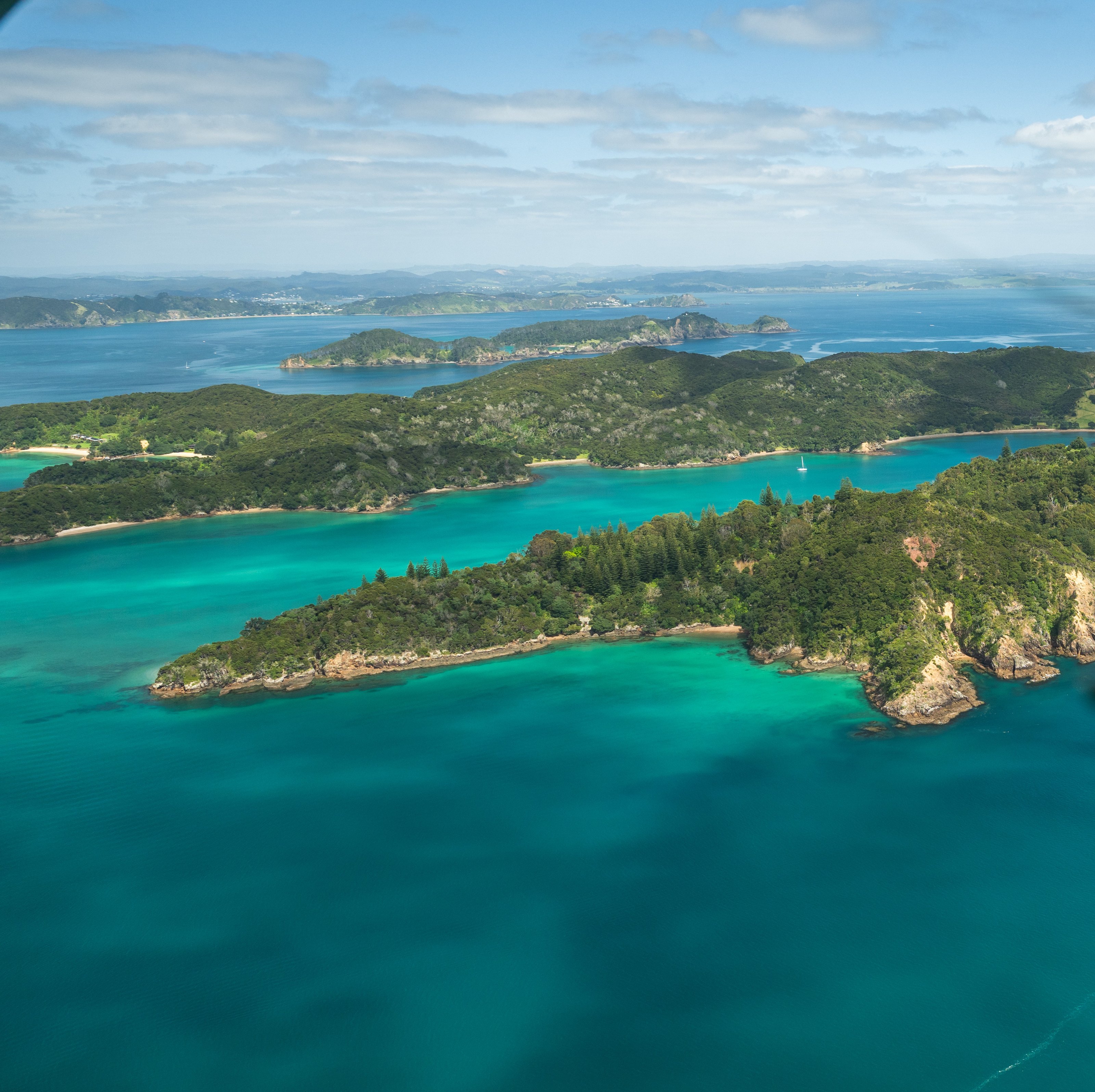The Bay of Islands from the air, turquoise water around the islands